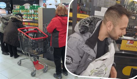 Pracownik Empiku obsługujący klienta przy kasie