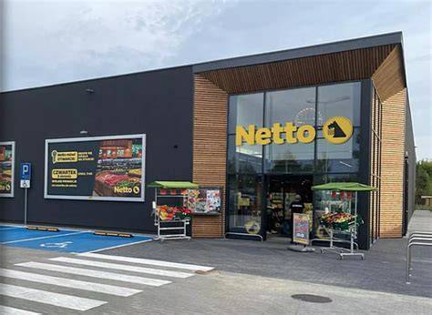 Logo Netto z psem trzymającym koszyk